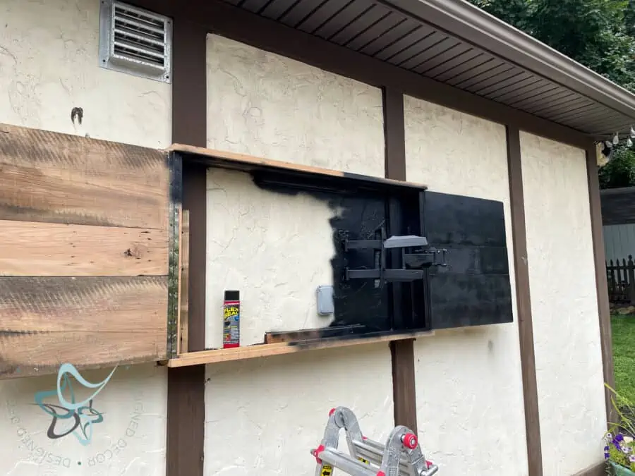 spraying waterproof spray to inside of TV cabinet