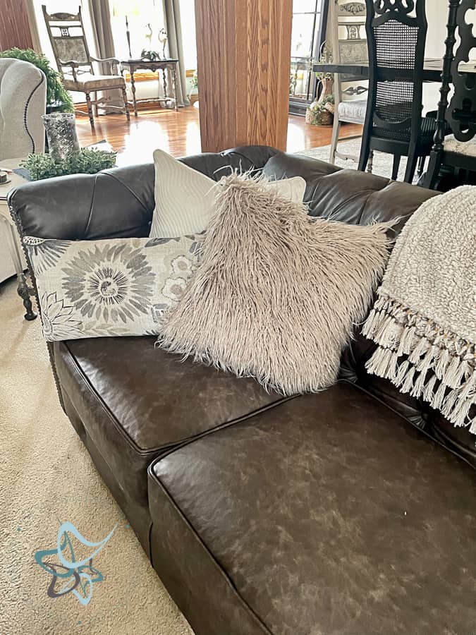 decorative pillows on a leather sofa