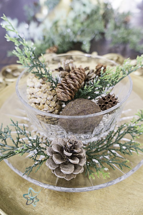 Dining room tablescape with pine cones and greenery