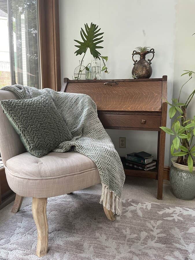 slipper accent chair next to an antique oak desk