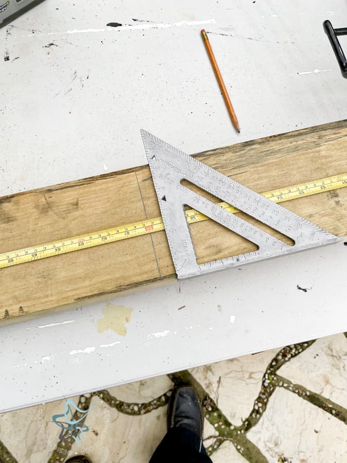 using a speed square to cut a 2 x 4