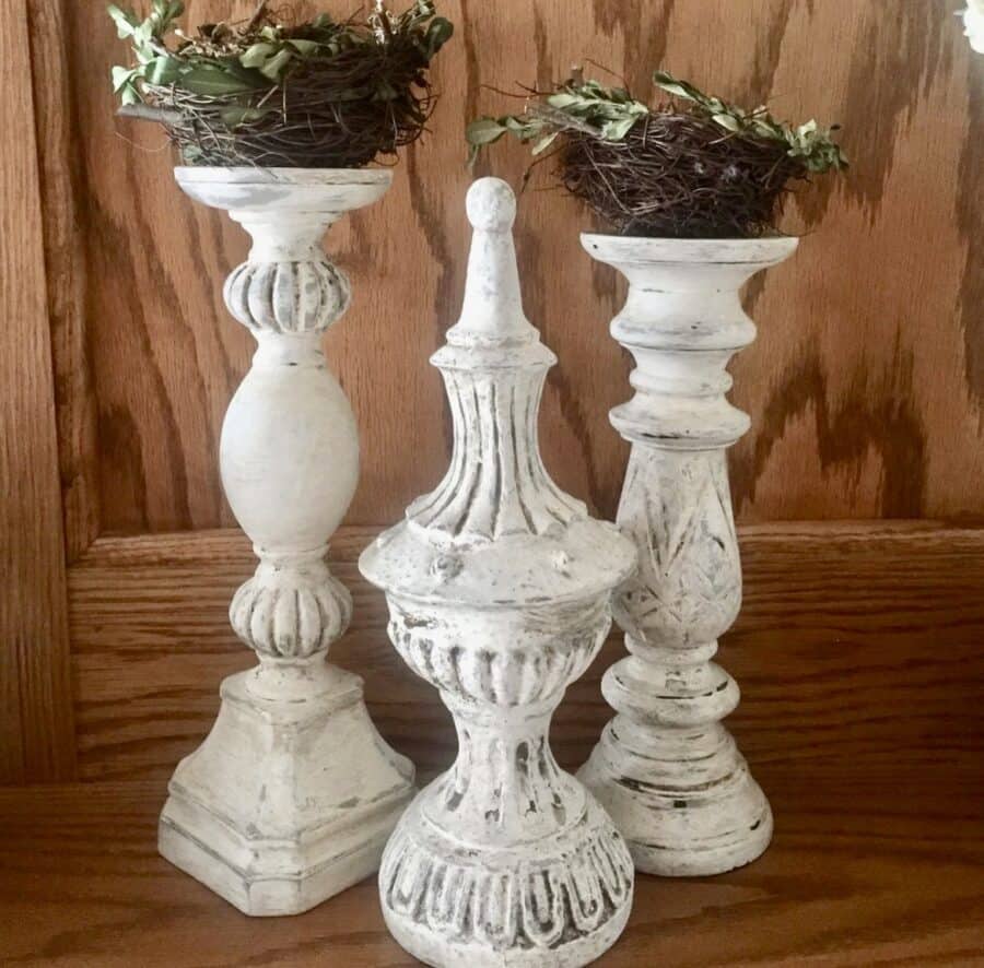 a set of 3 antique layered painted candlesticks