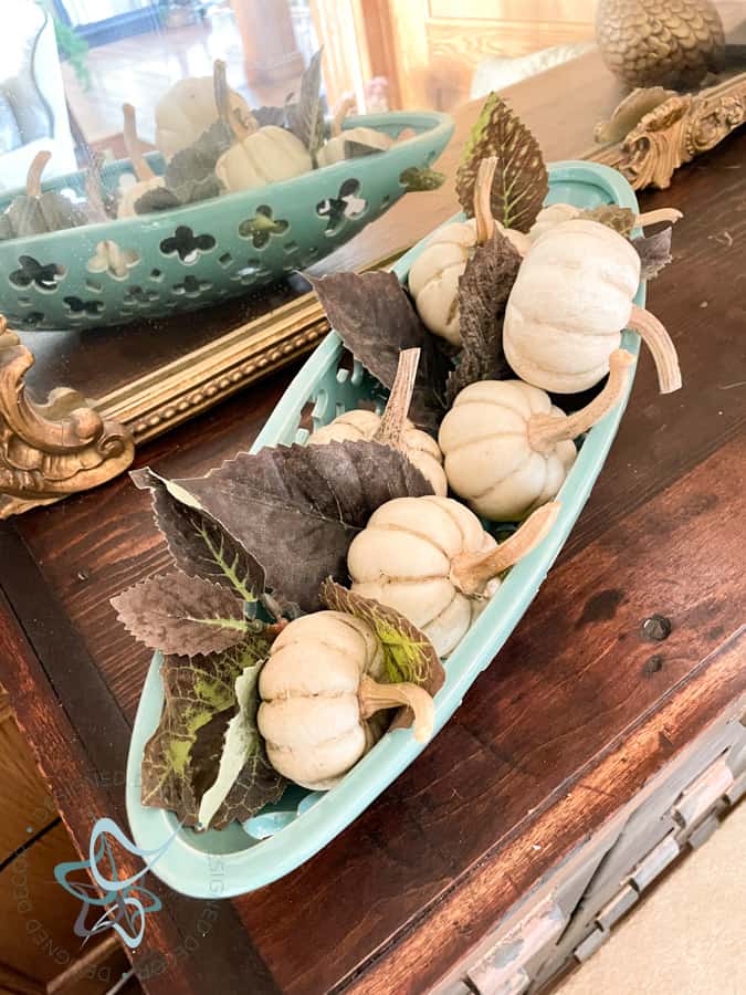 white baby boo pumpkins in a glass dish.