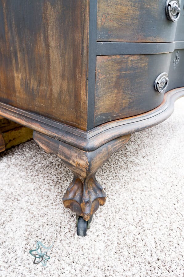 close up of lions foot on an antique secretary desk