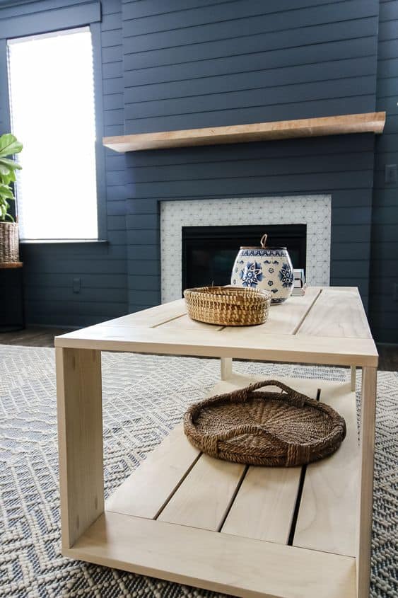 modern wood coffee table in a living room with a basket on the bottom