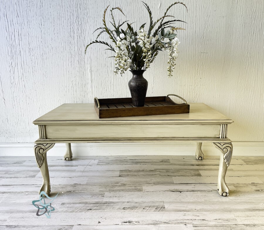 coffee table painted in cream with a serving tray on the table