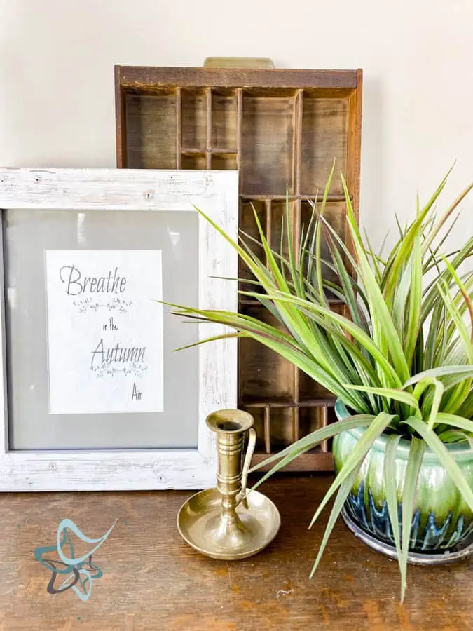 Fall vignette with frame, printer tray, and plant