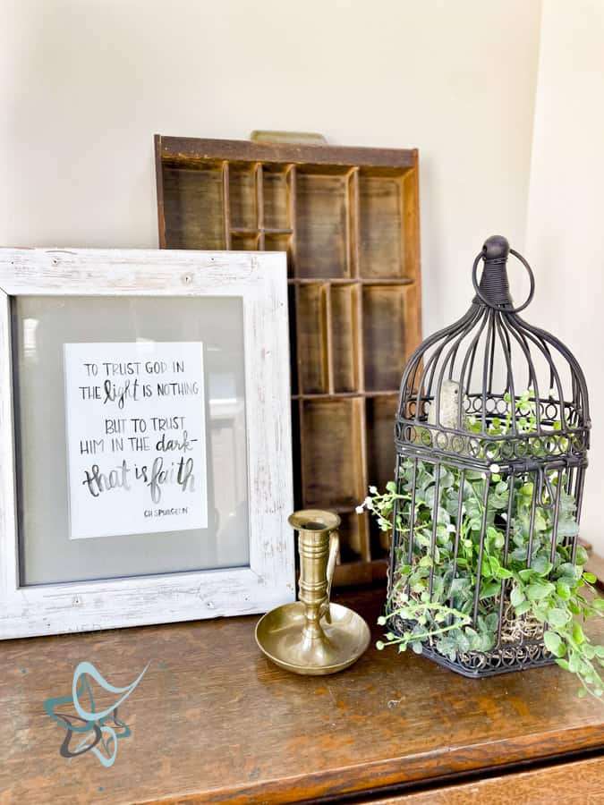 Spring vignette with frame, bird cage, and printer tray