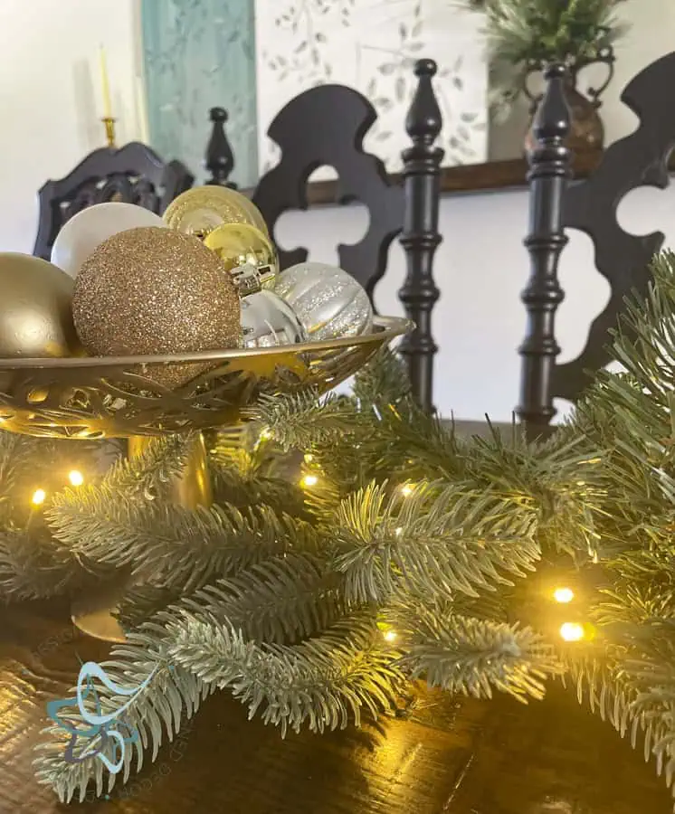 Dining table decorated with Christmas garland and candlesticks